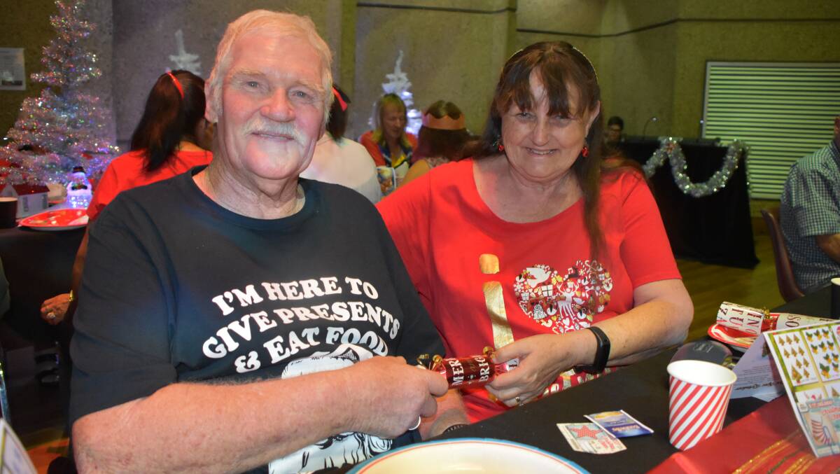 JINGLE BELLS: Wayne and Sylvia Shearsmith share a cracker over Christmas lunch at Mount Isa Civic Centre, for the over 60 crowd. Photo: Esther MacIntyre