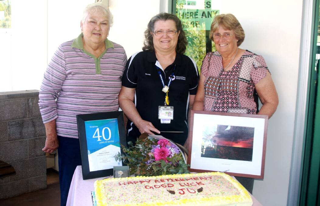 40 YEARS OF SERVICE: Jo's original Director of Nursing, Jan Schneckloth, Jo Gabbert, current Director of Nursing, Lesley Laffey, with goodbye gifts from NWHHS, Cloncurry Hospital, and Cloncurry Council. Photo: Esther MacIntyre  