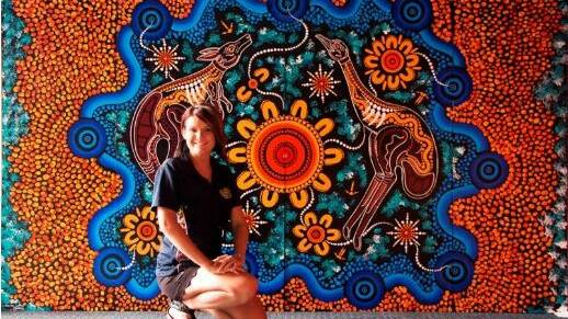 DREAMWORLD: Aritst Chern'ee Sutton with her Dreamworld memorial painting, dedicated to the four lives lost on the Thunder River Rapids ride. Photo: supplied