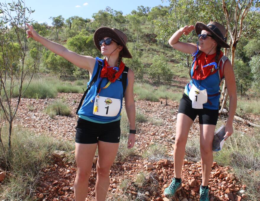 ADVENTURE TIME: 'Barely Bandits' team mates Ashleigh Burke and Yvette Wehlow abandon their masks and moustaches on an epic trek in the blazing sun through the outback at Lake Moondarra. Photo: Esther MacIntyre