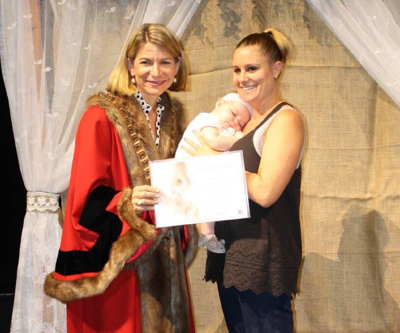 BABIES DAY: Echo Lexa Slade catches a snooze while Mum collects her official commemorative birth certificate from Mayor Joyce McCulloch. Photo: Esther MacIntyre