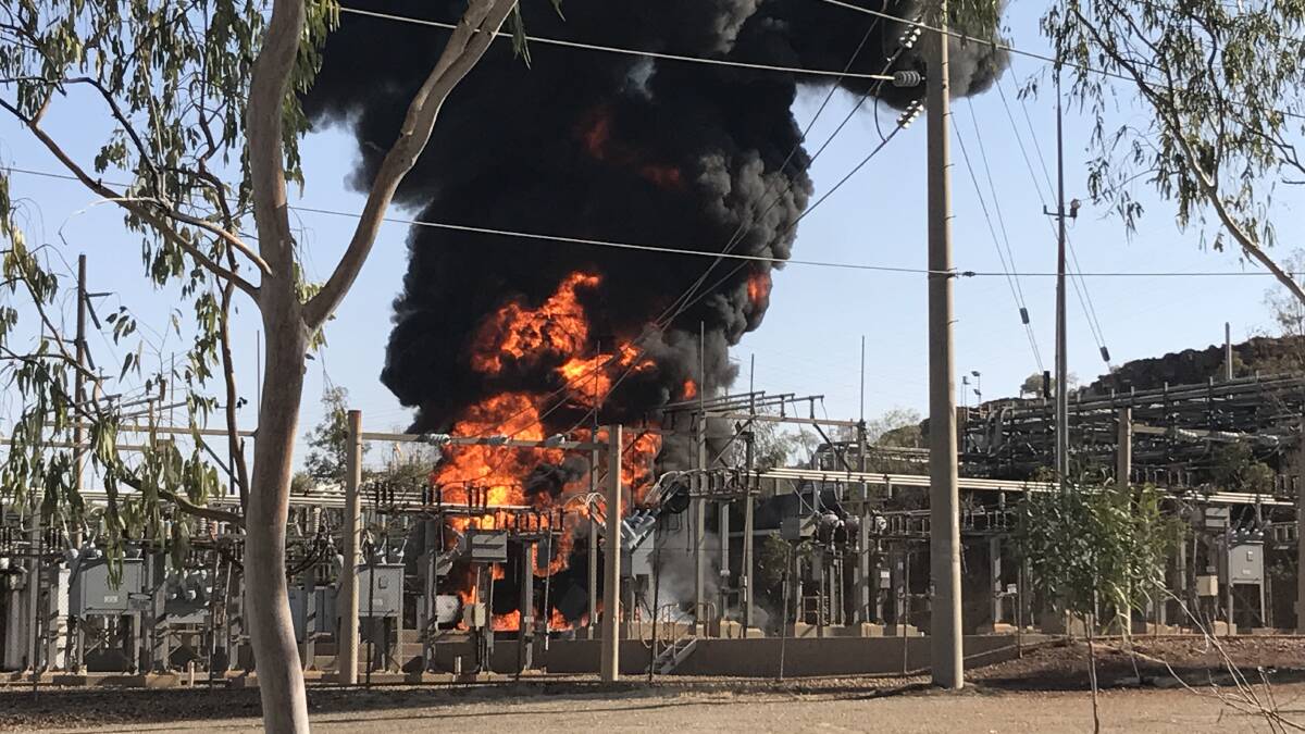 INFERNO: Mount Isa Police captured this back view of the burning power transformer on Monday, with dramatic black smoke and flames. Photo: Mount Isa Police