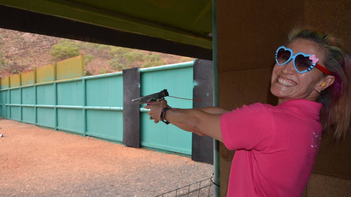 TAKE AIM: Susan Sparkle was jumping for joy at shooting her first gun at Mount Isa Pistol Club, with adrenaline running high. Photo: Esther MacIntyre.