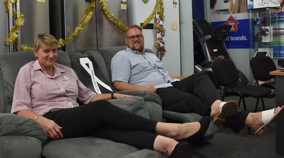 WEAR A PAIR: Sales staff at Radio Rentals Mount Isa, Amanda Wheeler and Michael Bounds, got into some classy heels to support White Ribbon Day this Saturday, November 25.