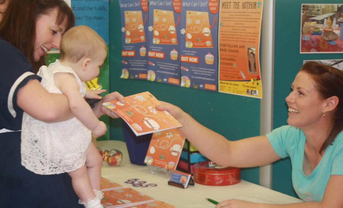 CUPCAKES AND FLOWERS: Rachel and Aine Healy (7 mth) pick up their signed copy of Cassandra Stephens' 'What Can I See?' at the launch at the library. Photo: Esther MacIntyre