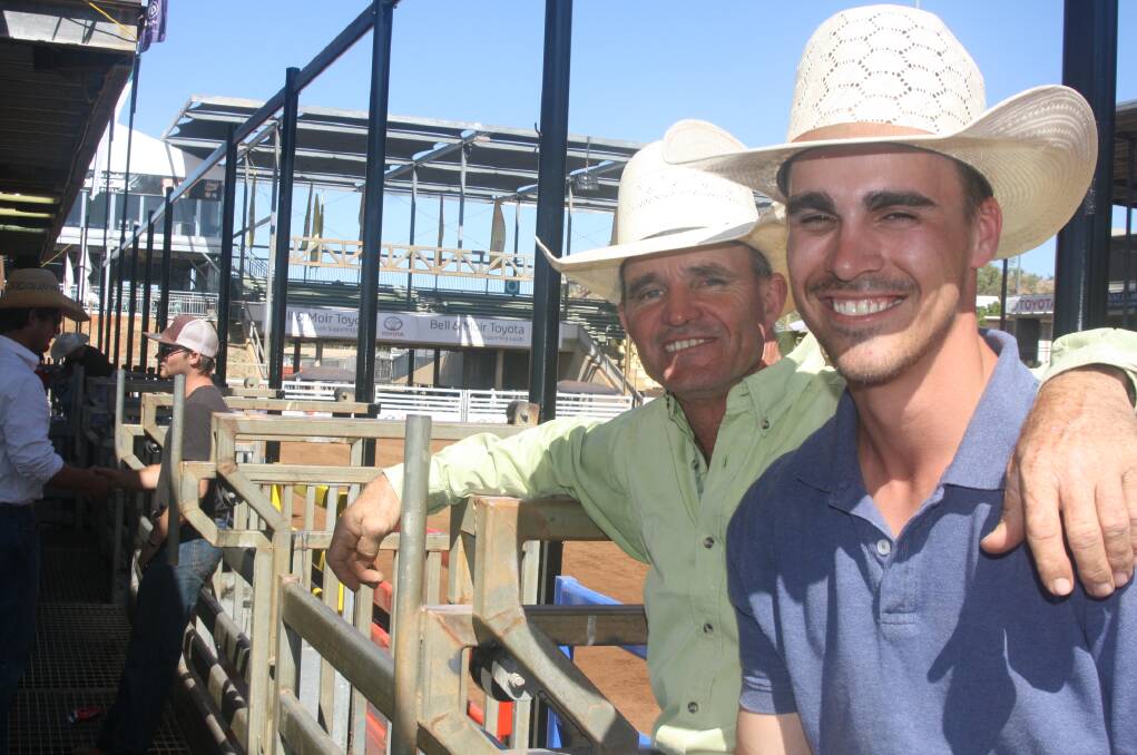 Two-time Australian former bull riding champion, Darren 'Brandy' Brandenburg, with son Nathan at Isa Rodeo School. Photo: Esther MacIntyre
