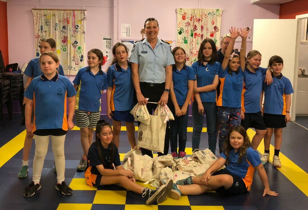GIRLS FOR WOMEN: Mount Isa Girl Guides working towards their Good Term
badge donated the toilet bags (filled with necessities) to Mount Isa Police, to pass on to a local women's shelter. Photo: supplied