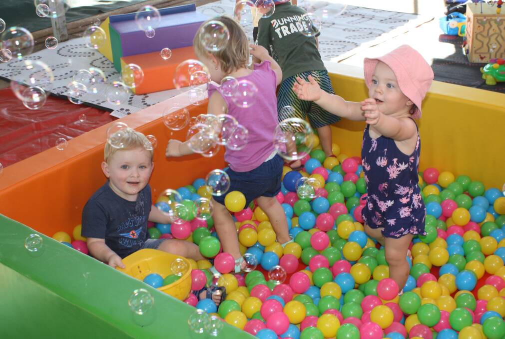 BUBBLES N BALLS: Jai (2), Sienna (2), and Isla (1) throw themselves into a day of messy play starting with a classic playground staple, the ball pit. Photo: Esther MacIntyre