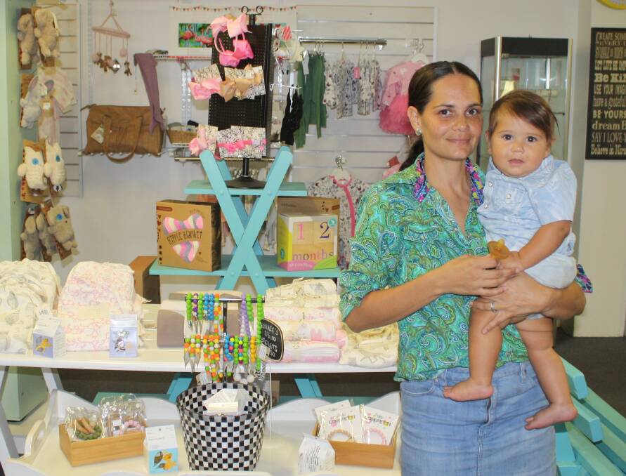 FRESH START: New manager Jaunita Doyle with son Urijah, welcoming Mount Isa to the new look Ruby & Birdie store, now selling men's and women's clothing. Photo: Esther MacIntyre