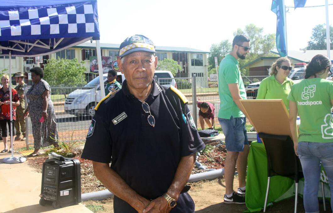 WORKING TOGETHER: Indigenous Police Liaison Officer (PLO), George Leon, about to raise the Australian, Police, and Aboriginal flags for the first time at Pioneer Police Beat. Photo: Esther MacIntyre