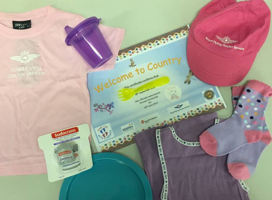 Baby packs with Welcome to Country certificate, RFDS t-shirt and cap, socks, utensils, and the wonderfully useful Sudacrem.