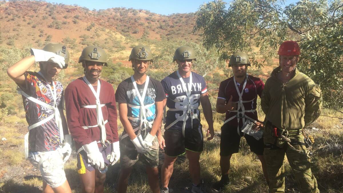 BOOYAH: Four young men graduate from Project Booyah in Mount Isa with life skills a'plenty, thanks to mentors like Major Jeremy Barraaclough (right). Photo: supplied
