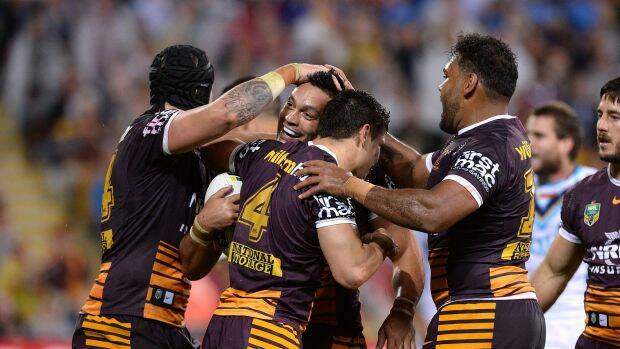 Hometown star: Alex Glenn enjoys the attention of teammates after his try. Photo: Getty Images
