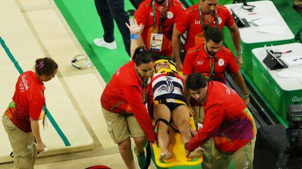Samir Ait Said of France raises his arm as he is stretchered off after breaking his leg. Photo: Scott Halleran
