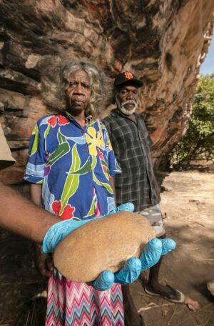 Traditional owners May Nango and Mark Djanjomerr with a stone axe found at the site. Photo: Glenn Campbell
