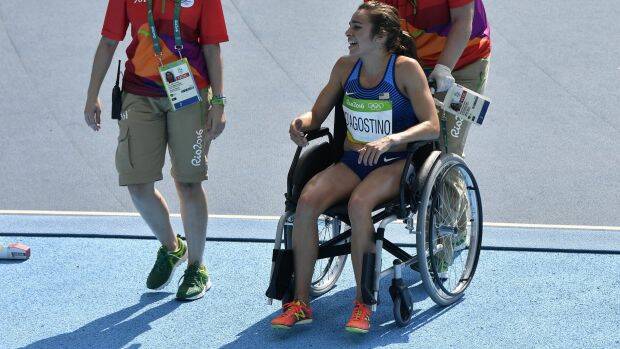 Abbey D'Agostino is helped from the track in a wheelchair Photo: Martin Meissner
