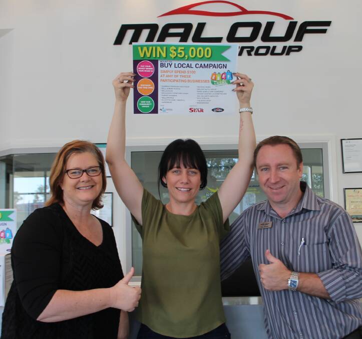 Katie Schrodter celebrated winning the buy local campaign with supporters; Commerce North West's, Sue Wicks and Malouf Auto Group's, Paul Malouf. 