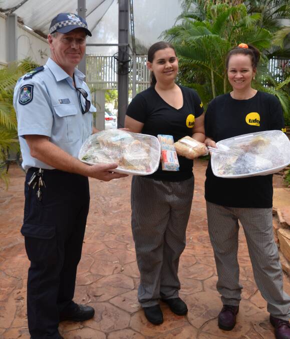 HELPING HAND: Senior Sergeant Col Henderson assists chef apprentices Jacqueline Rogers-page (Coffee Club) and Anne Caine (Mount Isa Irish Club) to deliver food platters. Picture: Bronwyn Wheatcroft 