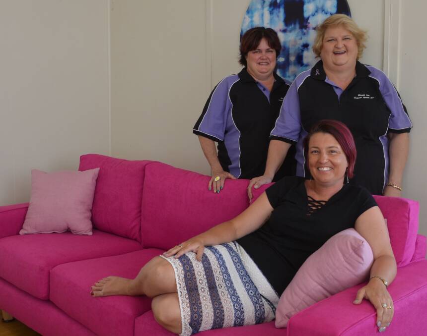 THINK PINK: Emma Harman of Pink Bitz tests out the new couch with Cancer House's Tania Gilmore and Linda Lawrenson. Photo: Melissa North
