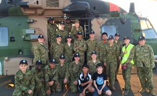 CADET EXPERIENCE: The cadets posed by an army helicopter at Mount Isa airport. Photo: Supplied