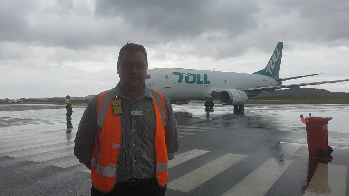 FOOD RELIEF: John Neal from Woolworths waited for the Toll frieght plane to unload 15 tonne of essentials. Photo: Melissa North
