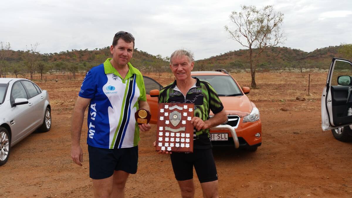 Tony Sweeney is presented with the trophy for the Andy Steffan handicap by a Copper City cycling Club official.