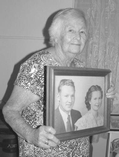 Gertraud Leippins (today) holding a photo of she and her husband taken in 1947.