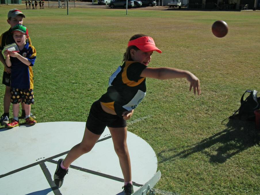 Thrown: Eight-year-old Anni-Rose Gowland throws the Shot Put at one of Moutn Isa Athletics Club's recent club days. Photo: Supplied.