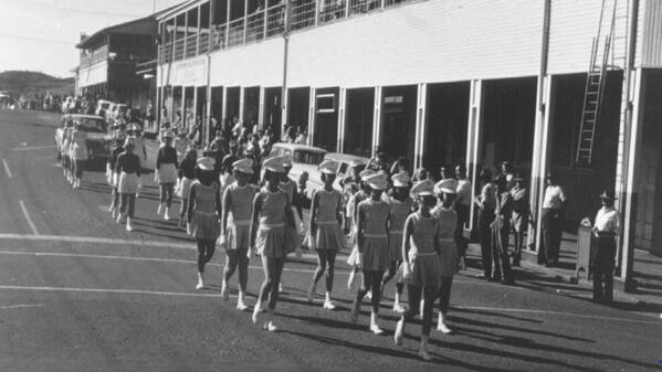 On the macrh: Mount Isa Marching Girls marching down Marian Street towards West Street corner. Circa 1963
