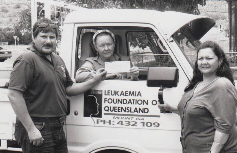 Mount Isa Motorcycle Club's Shelley Black presenting a cheque to Kath Swift to build the Leukaemia Foundations shed on Duchess Road in the mid 1980s. 