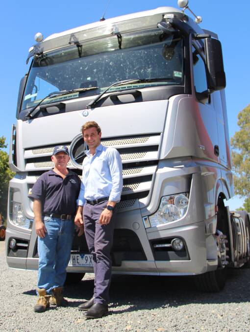 Top gear: Wagga resident and hay runner Shane Bourke with Hartwigs salesman Tom Anderson, picking up the generously donated prime mover. 