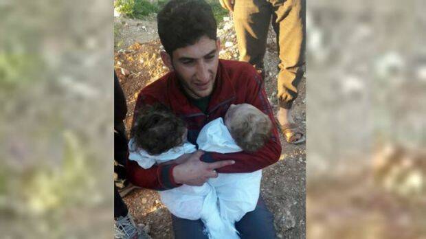 Abdul Hamid al-Youssef holds his twin toddlers who were killed during the suspected chemical weapons attack in Syria. Photo: AP
