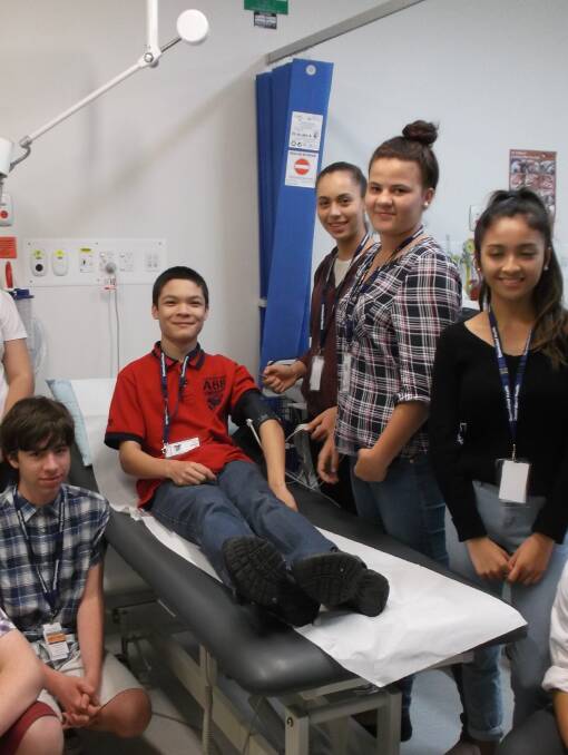 Student Adam Godwin gets his blood pressure checked by fellow work experience students at Mount Isa Hospital.