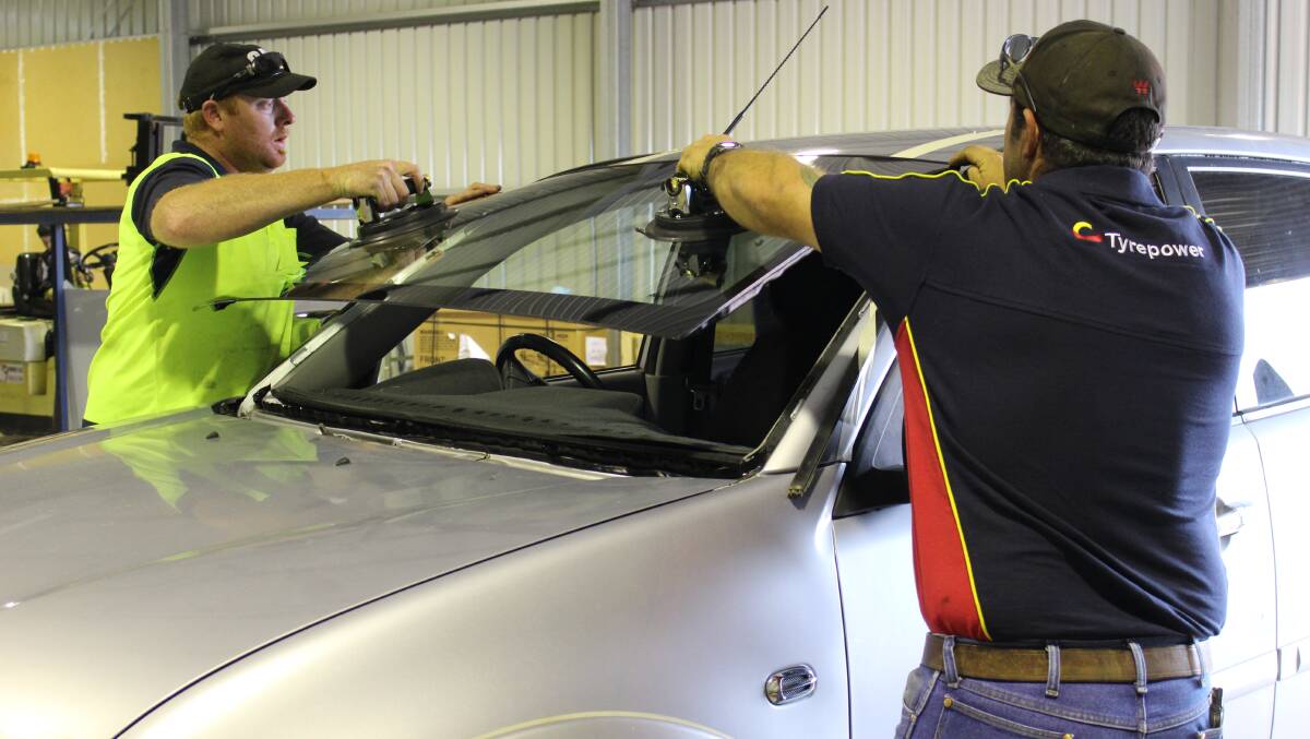 Branch manager Damien 'Red' Lethborg and owner Damion O’Loughlin fit a new windscreen.
