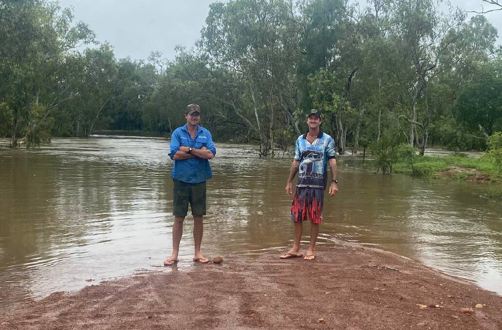 Tristan and Justin Gould at Lagoon Creek, what would usually be their main access road. Picture supplied by Tanya Gould.