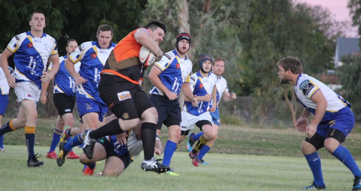 WARRIGALS DOMINATE: Cameron McKerrow ploughs his way through Cloncurry's defence but was sized up by Hamish Chrisp. Photo: Samantha Walton.