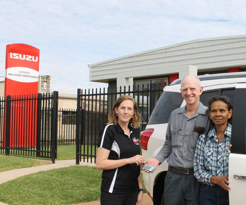 Welcome to Isa: Isuzu dealer principal Karen Pye handing over the keys to first delivery customers John and Tommy Senden from Cloncurry. Photo: Tess Thomas.