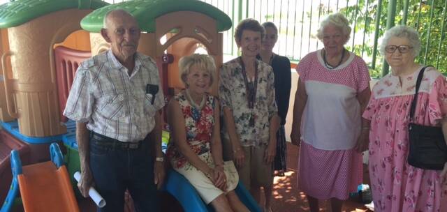 Members of the Mount Isa Hospital Auxiliary try out the new children’s play equipment on the deck of the Children’s Ward.