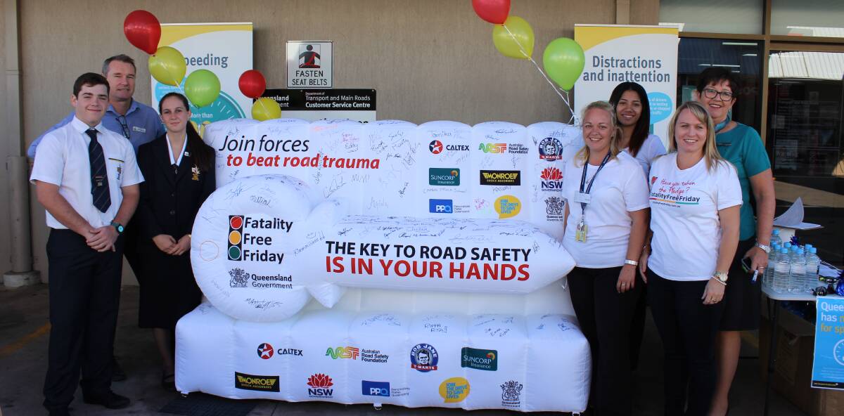 MAKE YOUR PLEDGE: Mount Isa Department of Transport and Main Roads staff and community members signing the inflatable key last Friday. 