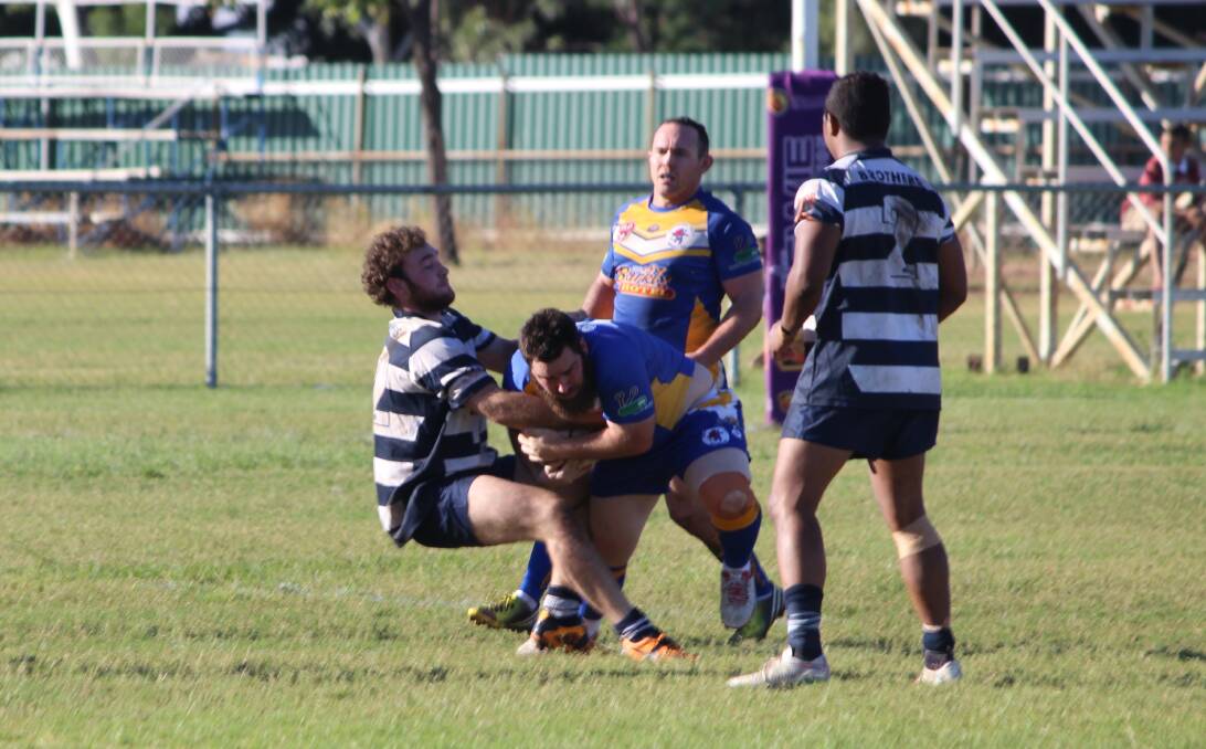 Who will win the competition: Casey Kempson making a tackle against a Wanderers player in Mount Isa on Saturday. Photo: Samantha Walton.