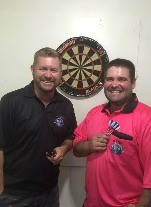 Brian Anderson and Clay McConnell prepare to battle on the dart board.