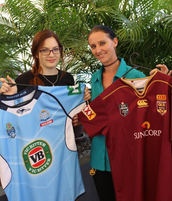 THAT'S MY TEAM: Barmaid Morgan Hannant and receptionist Cathie Thirlwall holding the State of Origin jerseys that will be given away at the Overlander Hotel next week. Photo: Samantha Walton.