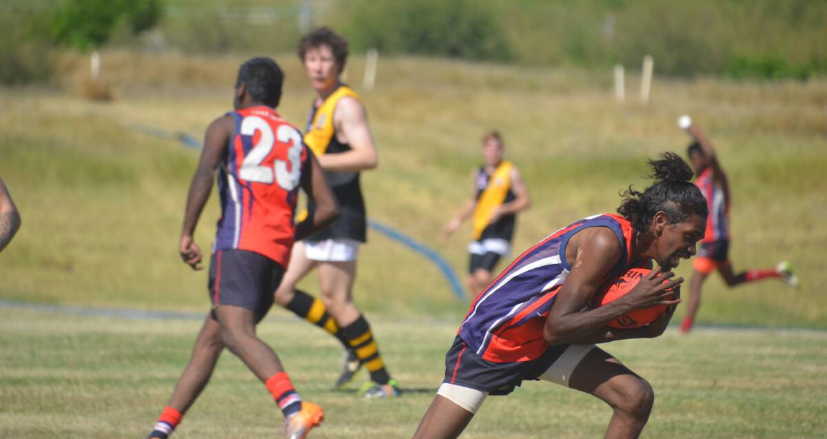 MARK: Young Guns beat Tigers in Round 1 of the Mount Isa AFL on Saturday. Photo Derek Barry.