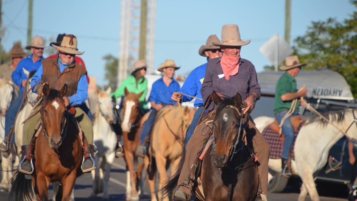 SADDLING UP: Drovers lead up the Friday street parade at the Camooweal Drovers festival on the weekend. Photo: Derek Barry