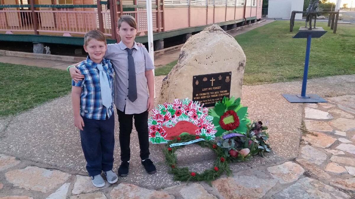 NEXT GENERATION: Jacob and Isaac Solah at the Camooweal war memorial on Anzac Day. Photo: supplied