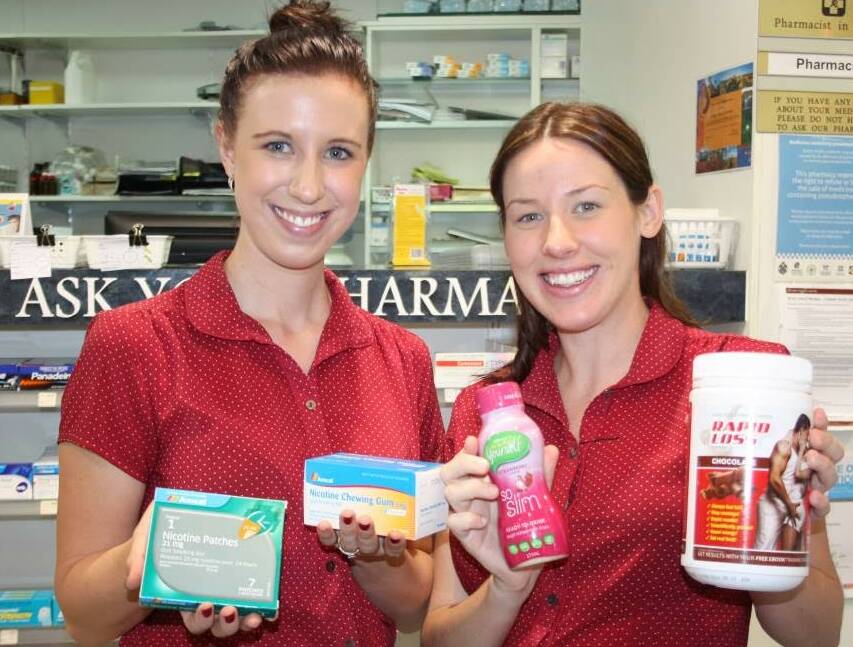 HAPPY NEW YEAR: Brooke Petrie, left and Hayley Delamare from Amcal Chemist, with a range of weight loss and quit smoking products. -Picture:ROZ FISHER/4908