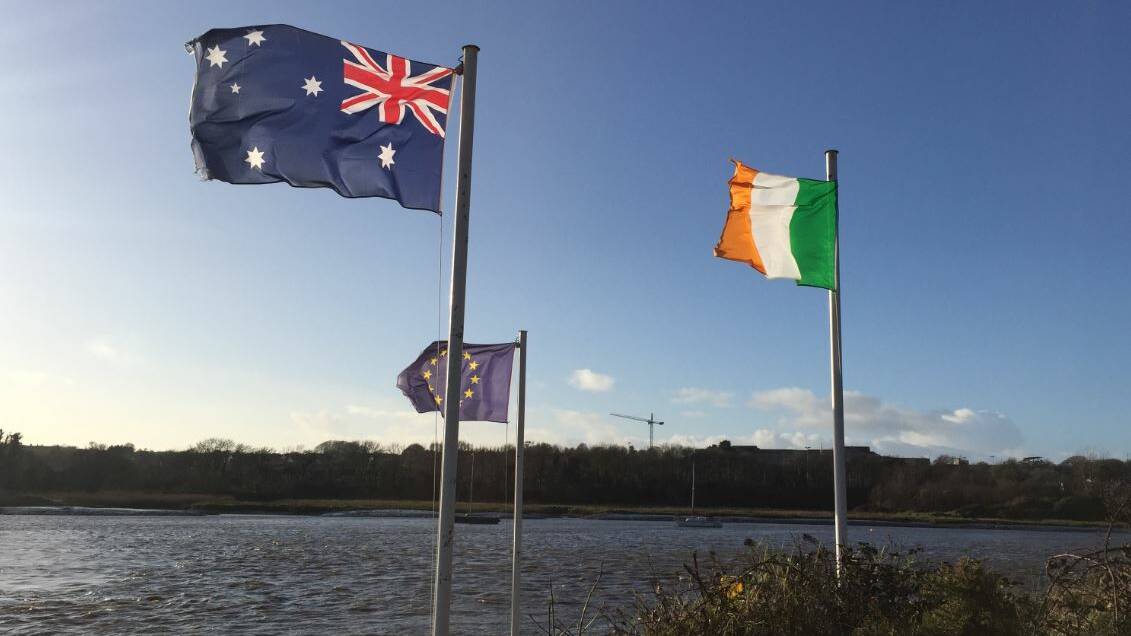 The Australian flag flutters next to the EU and Irish flags on the grounds on Waterford Castle by the banks of the River Suir, Waterford, Ireland.
