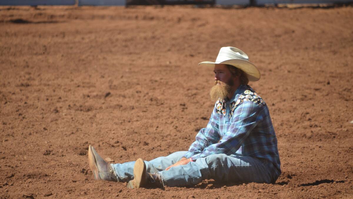 JUST MISSED: Last year's steer wrestling winner Lachie O'Neill contemplates life on the ground after failing to catch his beast at this year's Isa Rodeo. Photo: Derek Barry