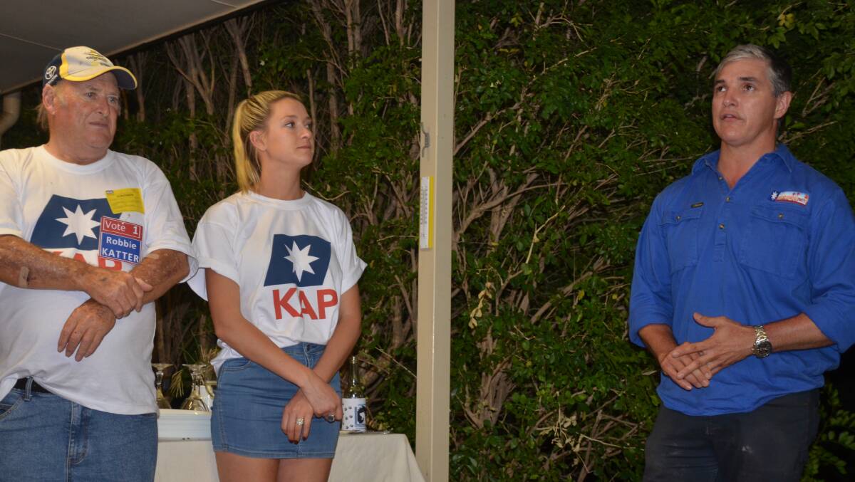 Robbie Katter speaks on Saturday night watched by wife Daisy and Steve Wollaston. Photo: Derek Barry