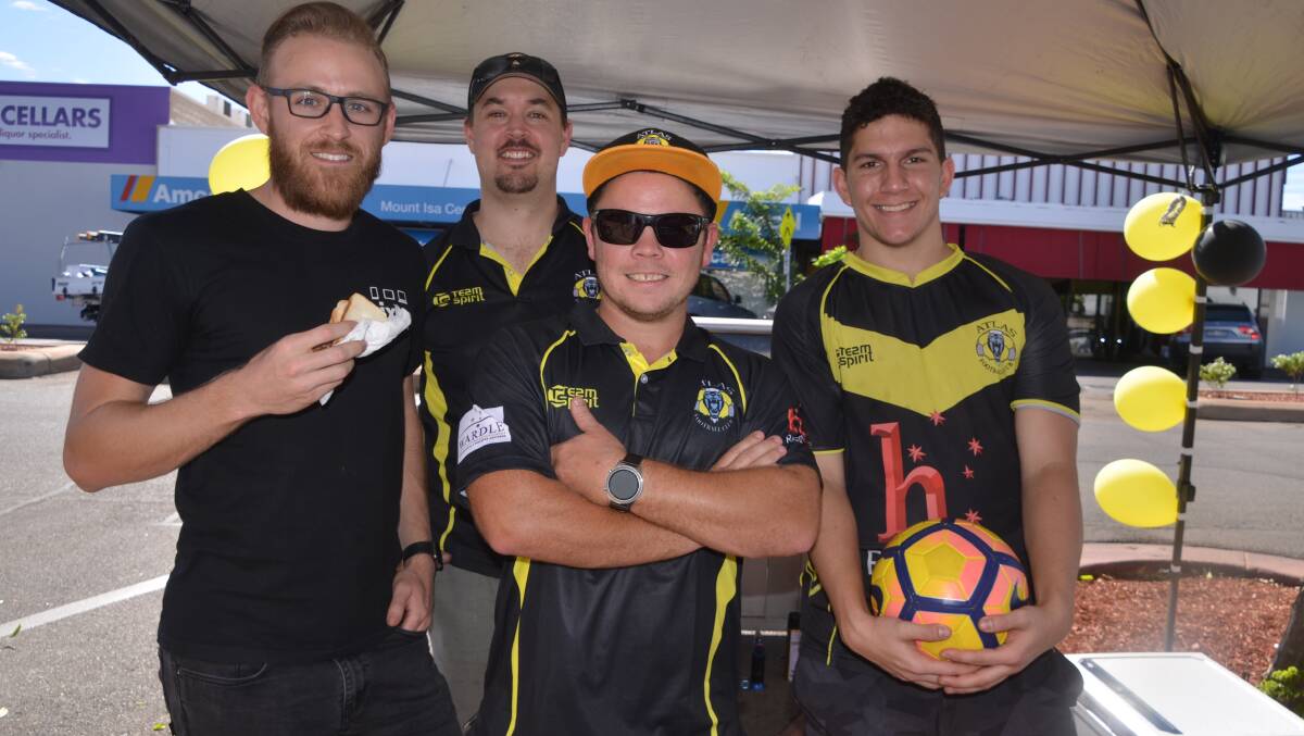 BARBIE KINGS: Andrew Frahm, Glenn Smith, William Cook and Thomas Cook fire up the sausage sizzle to support Atlas FC. Photo: Derek Barry
